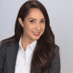 A woman in a suit and white shirt